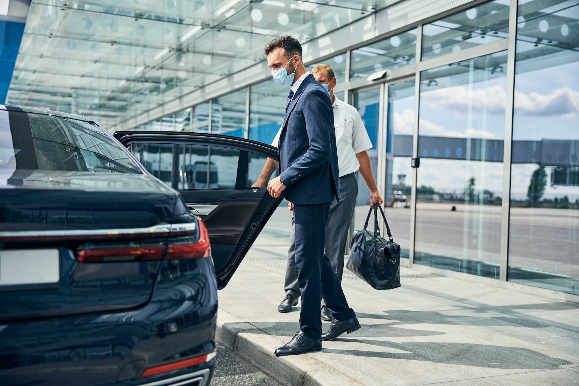 Handsome businessman taking taxi at the airport